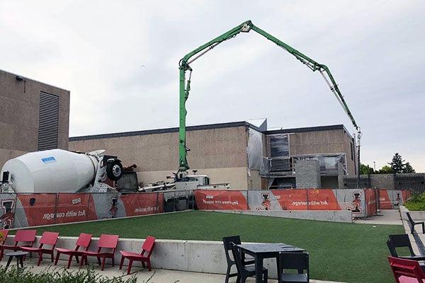 a concrete truck is pumping concrete